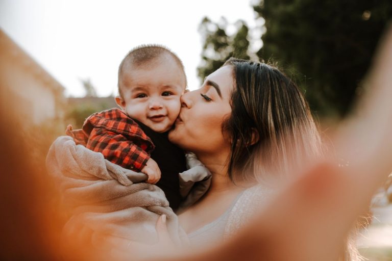 a mom kissing her baby boy: a lesson about God's love