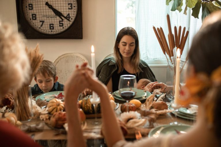 a family giving thanks at thanksgiving