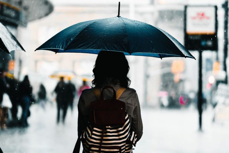 a woman standing peacefully in the midst of a storm