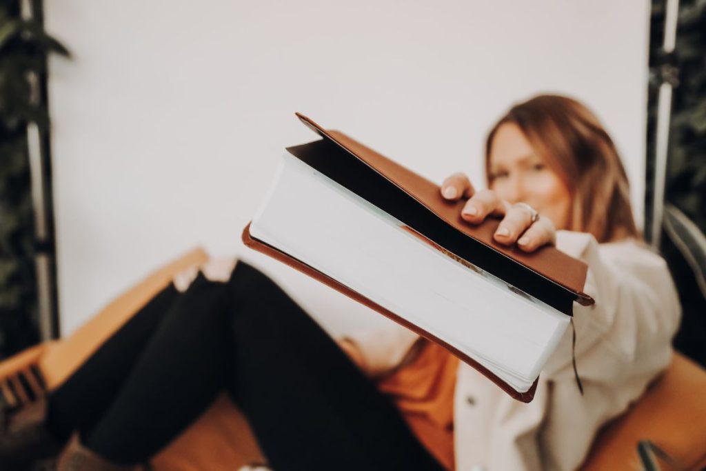 woman holding out her bible and smiling