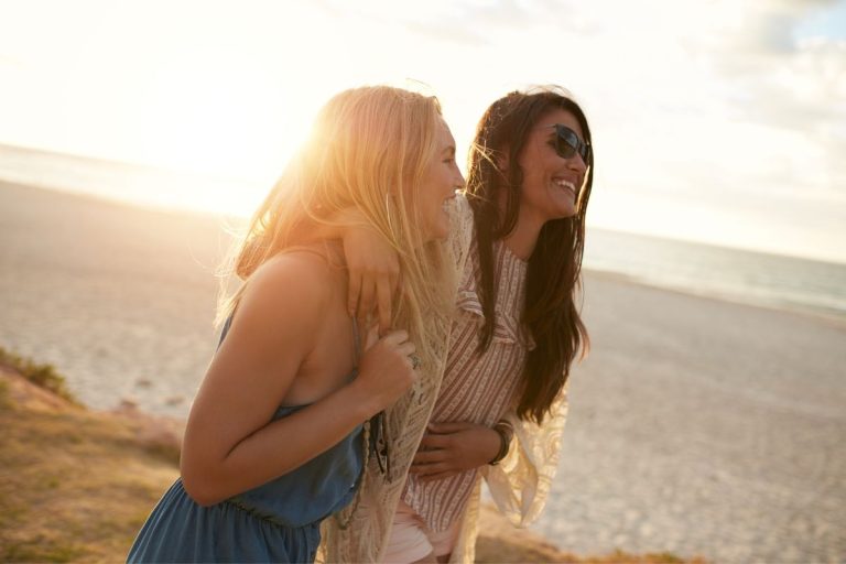 two girls laughing at the beach