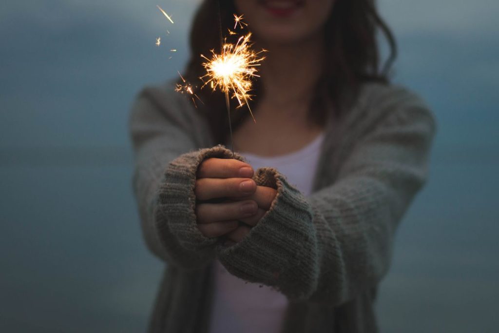 a woman holding a sparkler