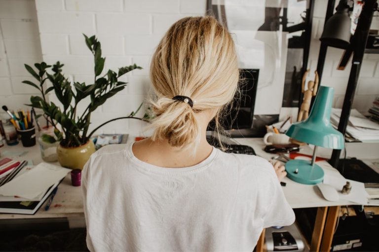 woman sitting at a busy desk