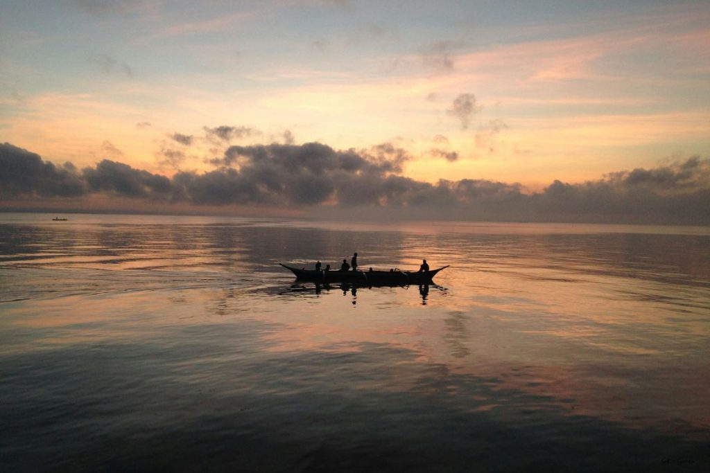 people out on a boat at dawn