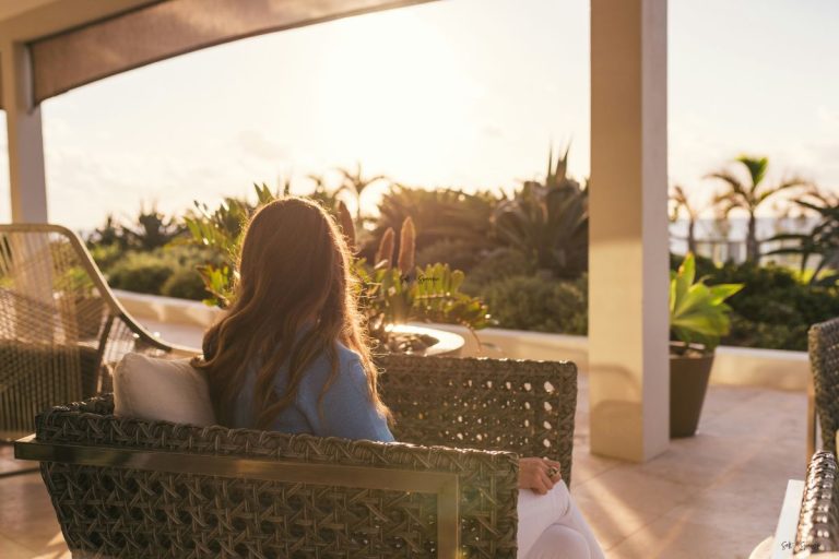 a woman sitting outside as the sun rises