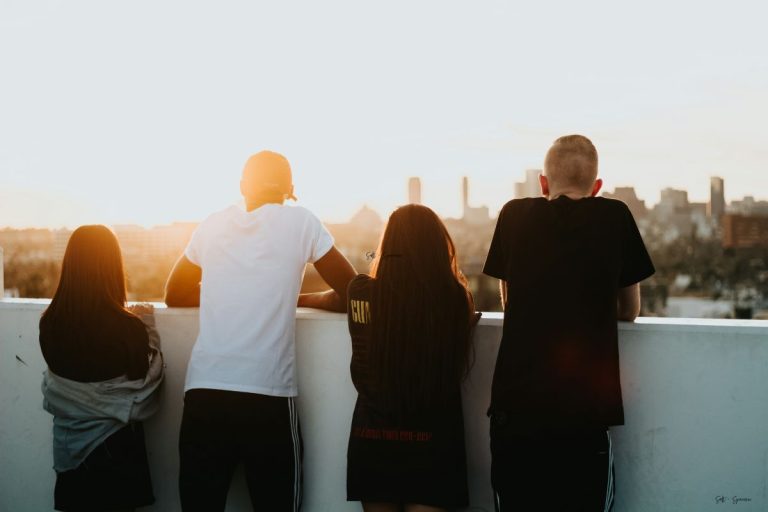 group of friends staring out at the city