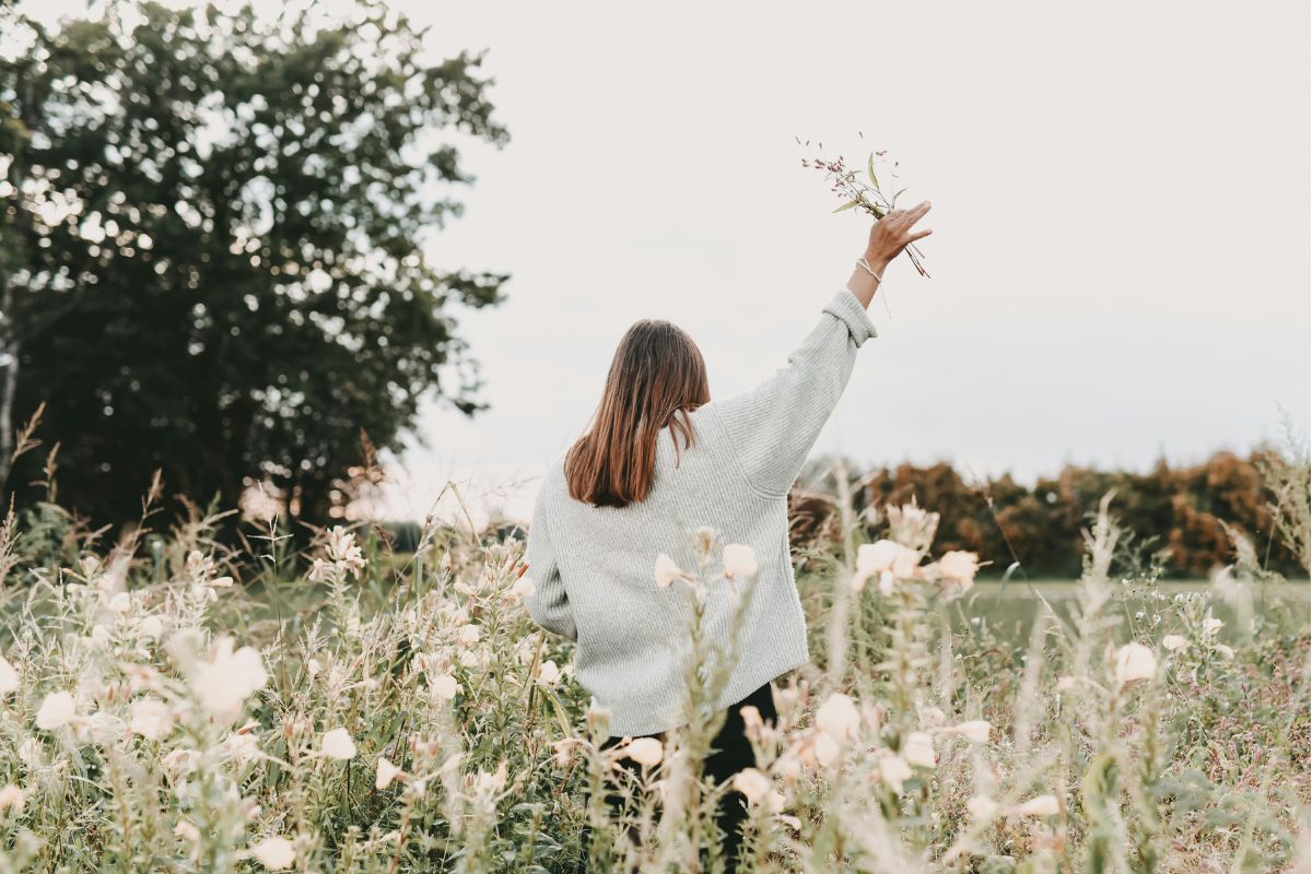 a woman in a field of wildflowers