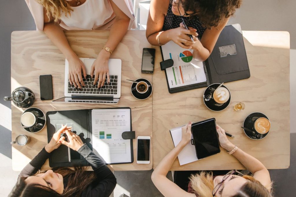 a group of women around a work table
