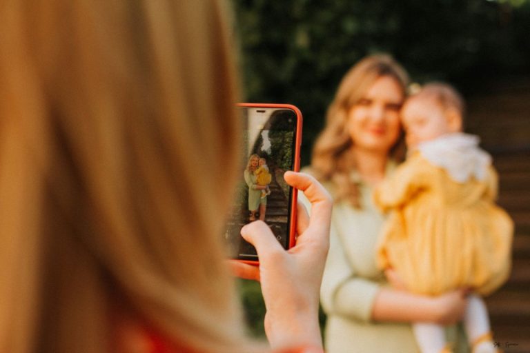 a mom and her child getting photos taken on a cell phone