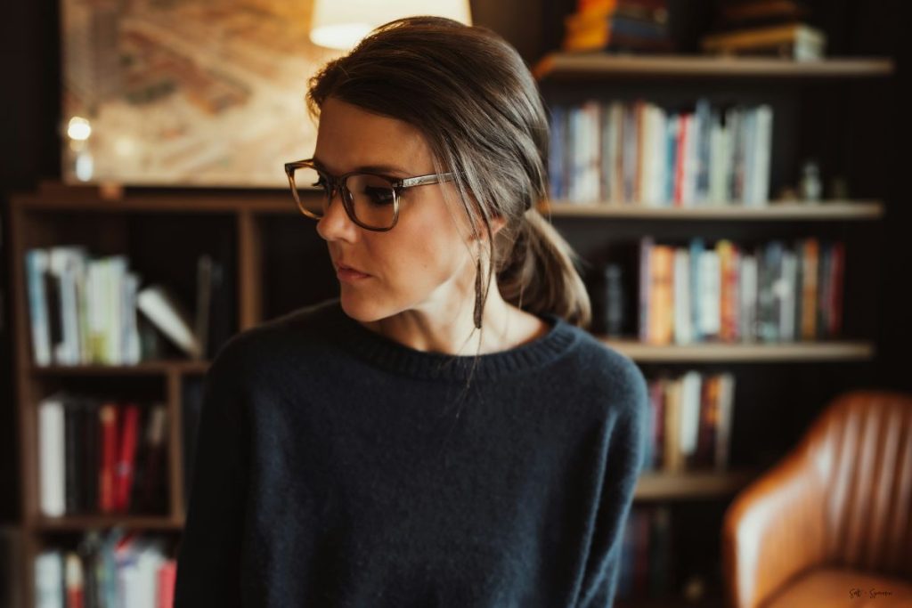a woman staring off to the side, she appears to be withdrawn