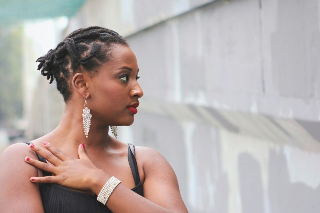 a woman looking off to the side at a cement wall as she's walking outside