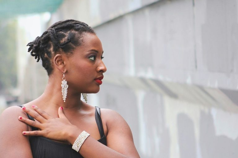 a woman looking off to the side at a cement wall as she's walking outside