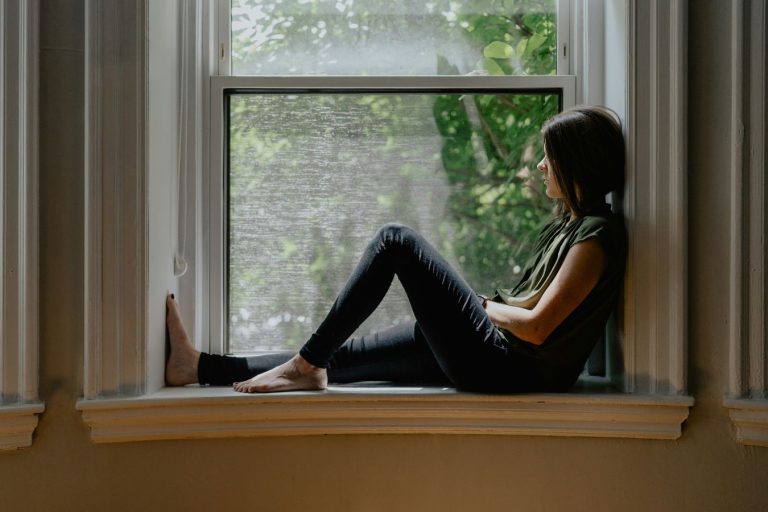 girl sitting in her widowseat looking outside