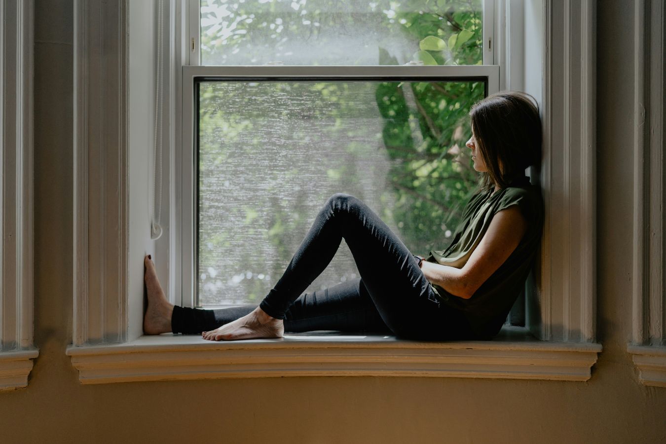 girl sitting in her widowseat looking outside