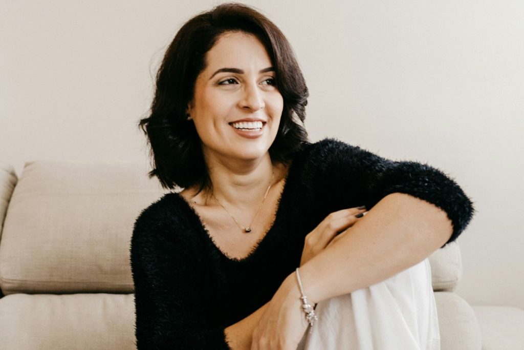 a woman with short dark hair smiling