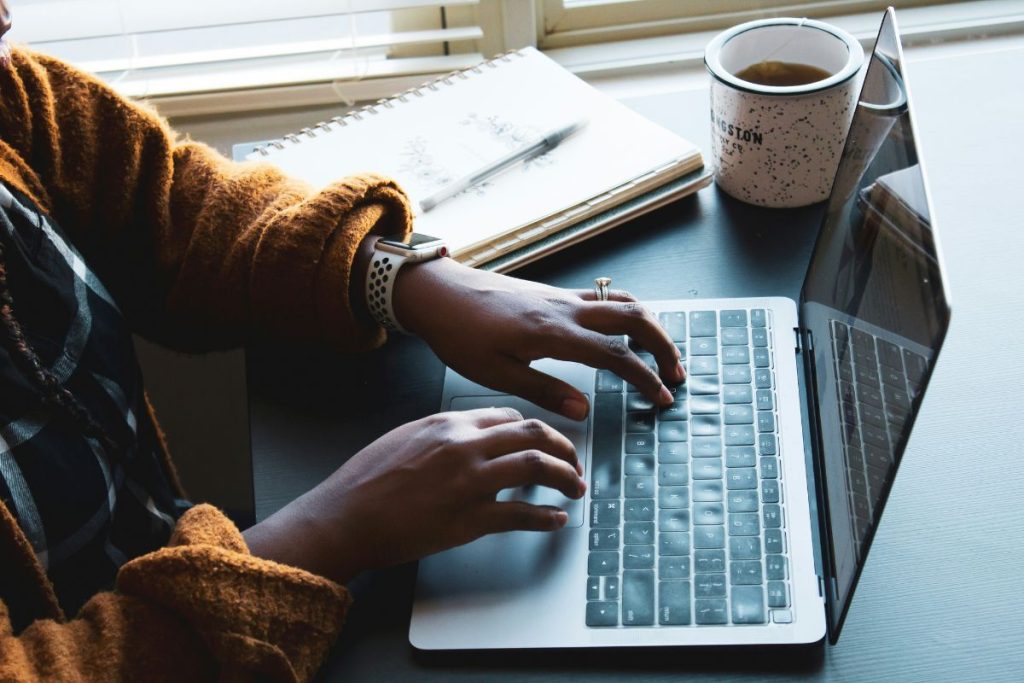 woman typing on her laptop