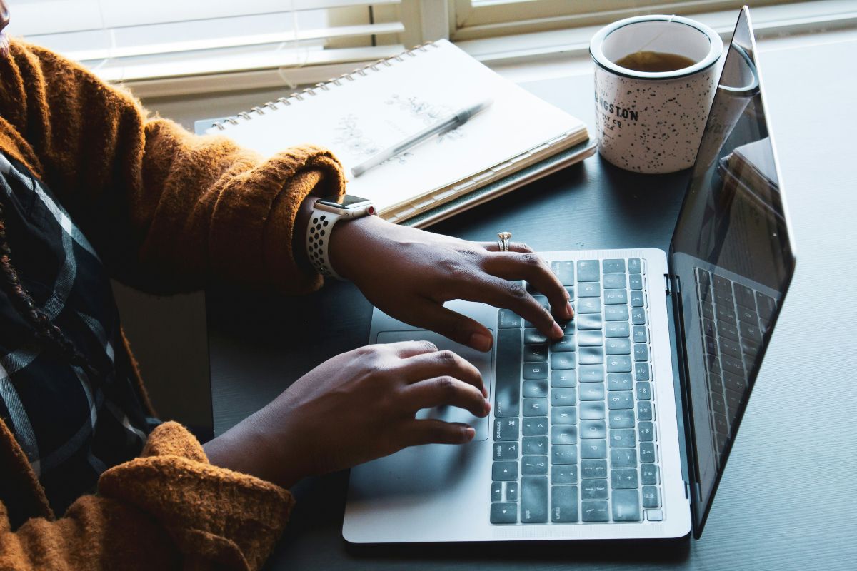 woman typing on her laptop