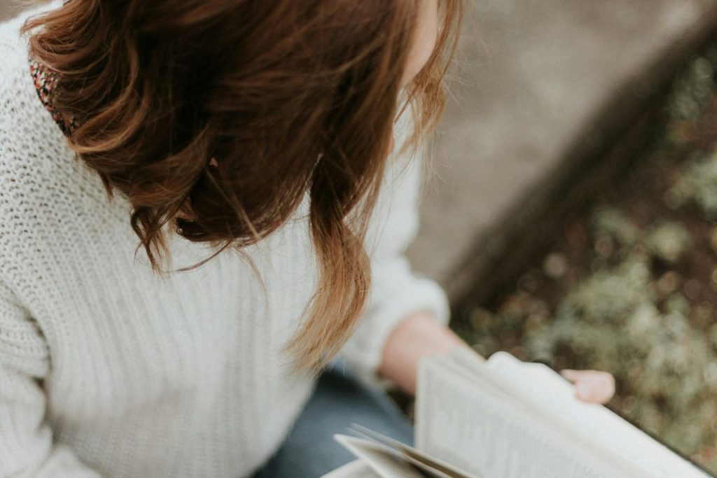 a woman flipping through her bible