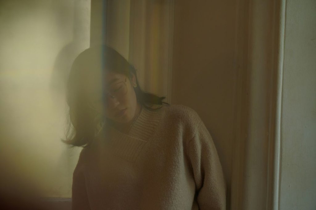 a blurry image of a woman that gives the impression she's coming undone
