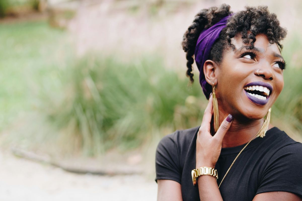 a woman staring off to the side while laughing, she looks joyful